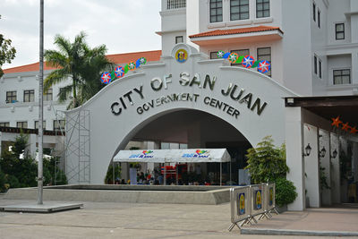 Information sign on street against buildings in city