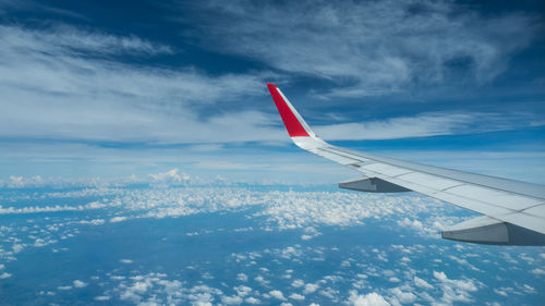 Cropped image of airplane flying over sea