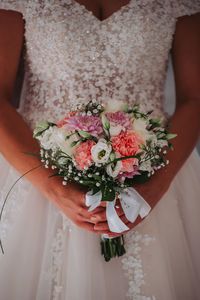 Midsection of woman holding flower bouquet