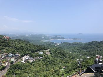 High angle view of buildings and trees against sky