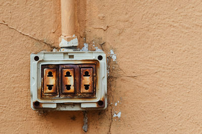 The dangerous old electric plug on wall