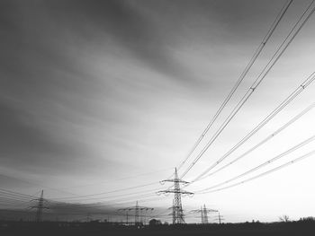 Low angle view of electricity pylon against sky