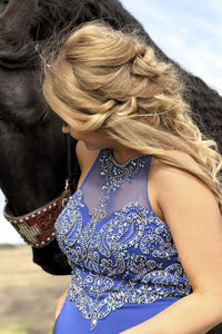 Woman with horse standing outdoors