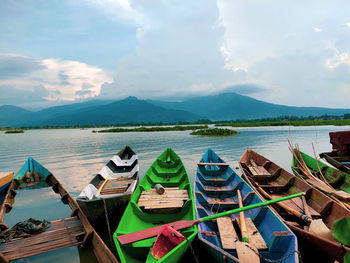 Boats moored in lake against sky