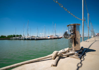 Sailboats in sea against clear sky