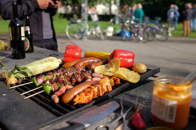 Close-up of food on barbeque grill against road