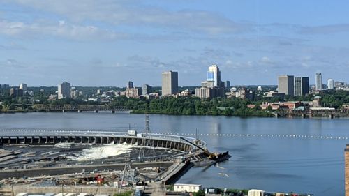 Bridge over river against buildings in city