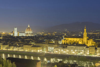 High angle view of city lit up at night