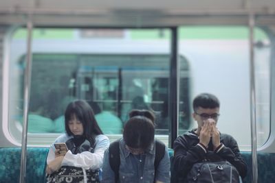 Rear view of people traveling in train