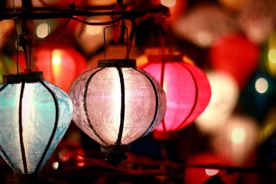 Close-up of illuminated lanterns hanging at night