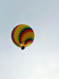Low angle view of hot air balloons against clear sky