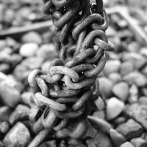 Close-up of rope tied to chain