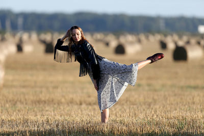 Full length of woman standing on field