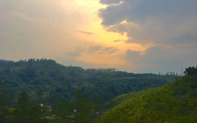 Scenic view of landscape against cloudy sky