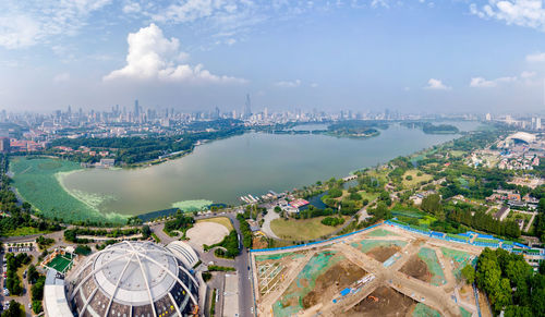 High angle view of buildings against cloudy sky