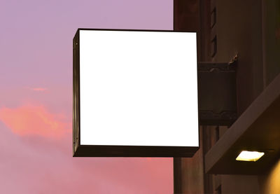 Low angle view of illuminated lamp against sky