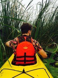 Rear view of boy in boat