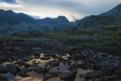 Scenic view of rocks and lake against sky