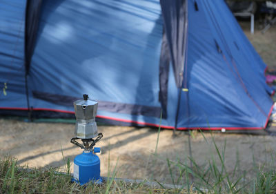 Breakfast with coffee warming up on a camp stove at a campsite