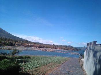 View of calm blue sea against cloudy sky