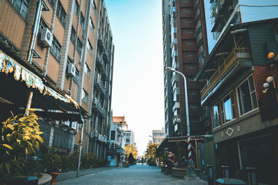 Low angle view of buildings in city against sky