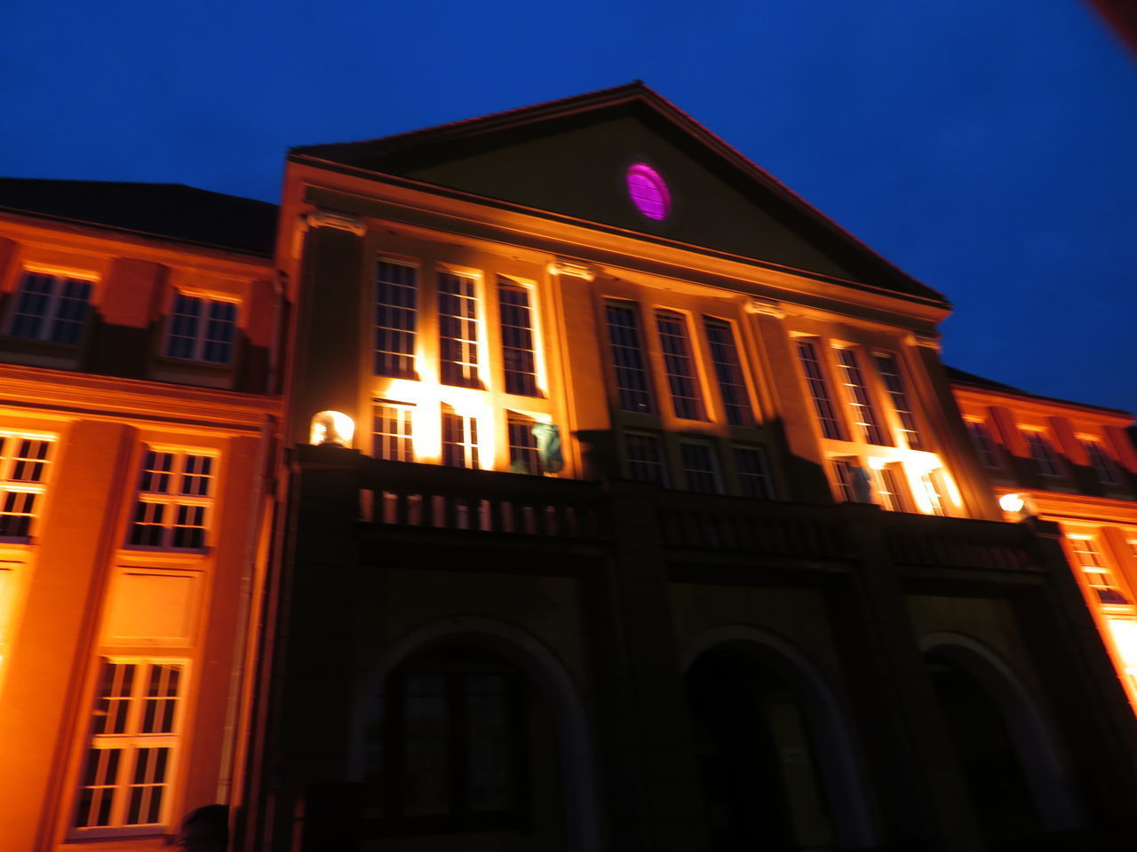 LOW ANGLE VIEW OF ILLUMINATED BUILDING AGAINST SKY