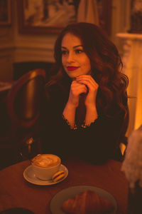 Smiling woman drinking coffee in cozy cafe closeup. good morning. selective focus.