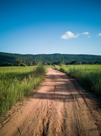 Empty road along countryside landscape