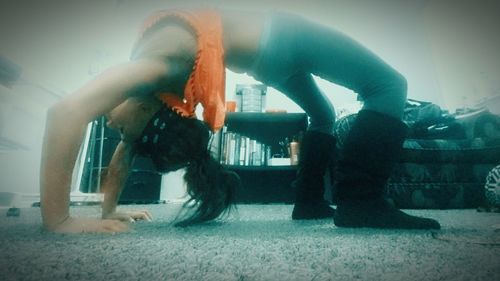 Full length of woman standing on bench