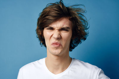 Portrait of mature man against blue background