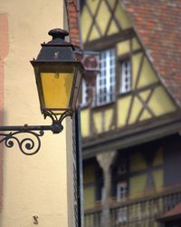 Low angle view of street light against building