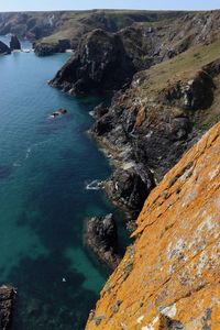 High angle view of rocks on sea shore