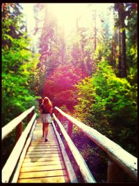 Full length of woman walking on forest