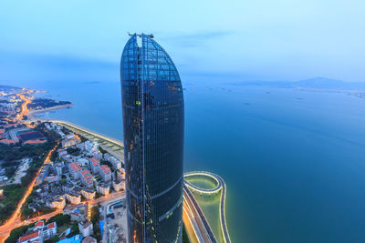 High angle view of cityscape by sea against sky