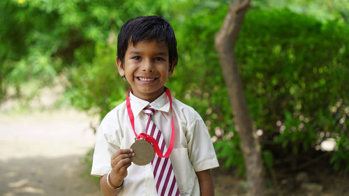 Portrait of young man holding digital tablet