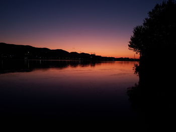 Scenic view of lake against orange sky