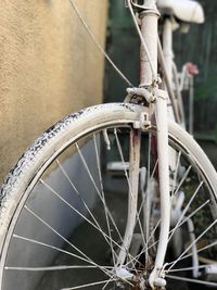 Close-up of bicycle wheel against wall