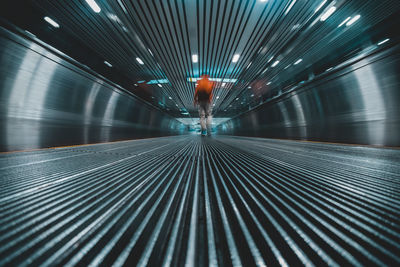 Rear view of man walking on walkway