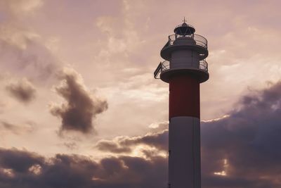 Low angle view of lighthouse against sky during sunset