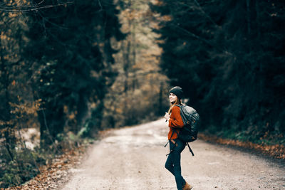 Full length of man walking on footpath