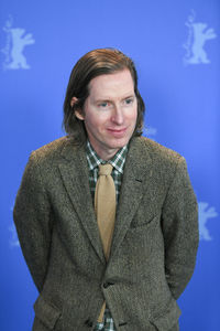 Portrait of smiling man standing against blue background