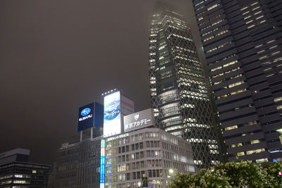 Low angle view of illuminated skyscrapers against sky at night