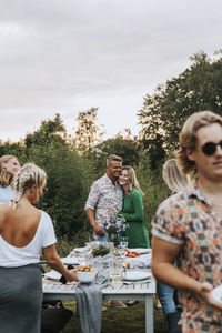 Friends standing on table against people