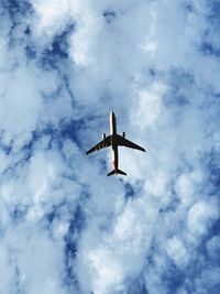 Low angle view of airplane flying in sky