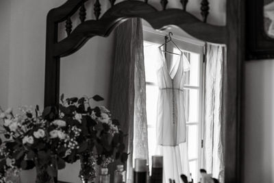 Low section of woman standing by window