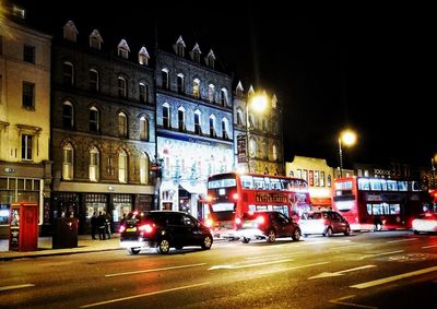 Cars on road in city at night