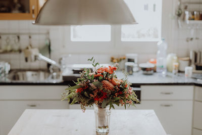 Close-up of flower vase on table at home