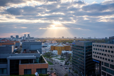 Evening sun rays shining through the clouds over potsdamer platz, berlin, germany in april 2019.