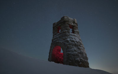Ancient lookout tower against the background of the starry sky. winter time