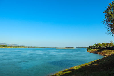 Scenic view of sea against clear blue sky